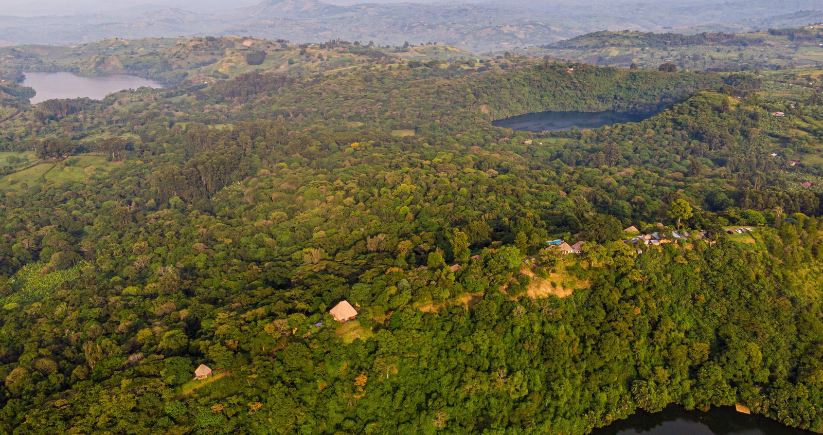 Aerial view of Ndali Estate forest showing Ndali Lodge, Lake Nyinambuga, Lake Rukwanzi and in the distance Lake Mwamba just off of Ndali Estate 