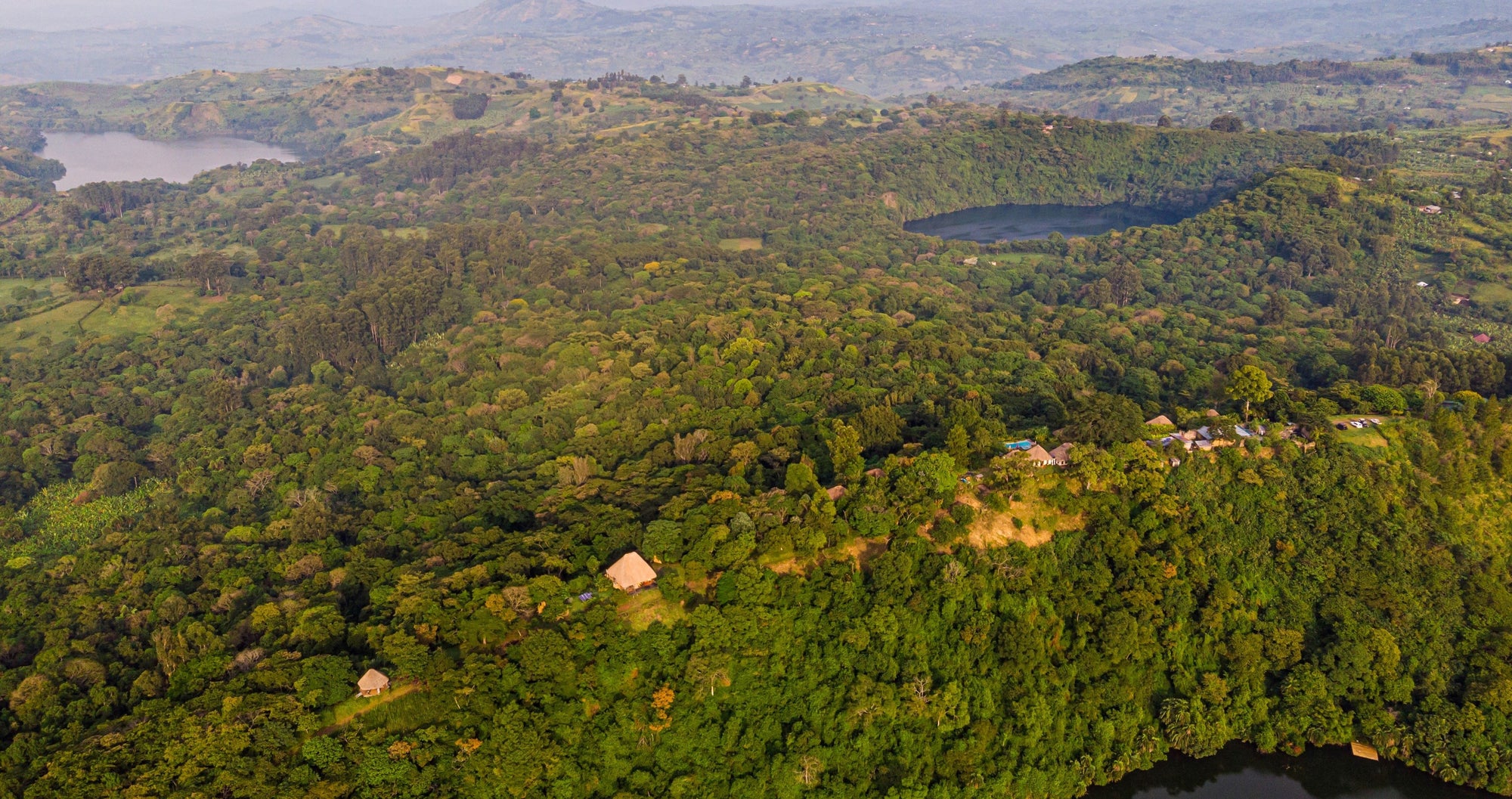 Aerial view of Ndali Estate forest showing Ndali Lodge, Lake Nyinambuga, Lake Rukwanzi and in the distance Lake Mwamba just off of Ndali Estate 